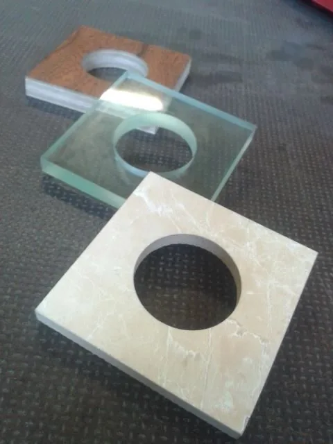 Wood, glass, and stone samples cut on Scott's VICHOR waterjet