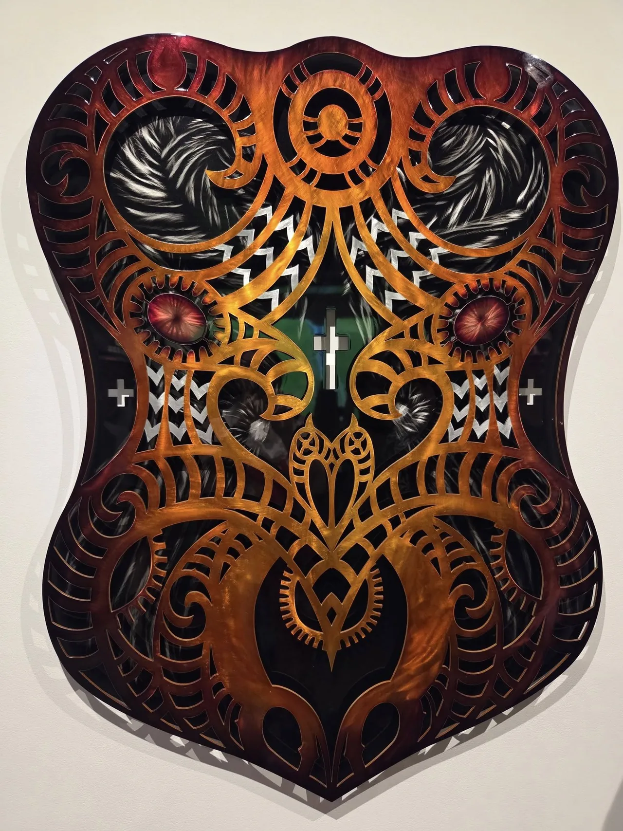 Red and orange Maori-inspired shield artwork cut by Scott's Steelworkz