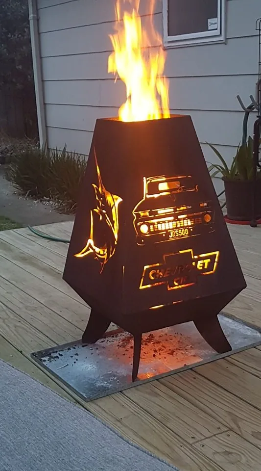 Chevy-themed firepit cut by Scott's Steelworkz with flames burning inside